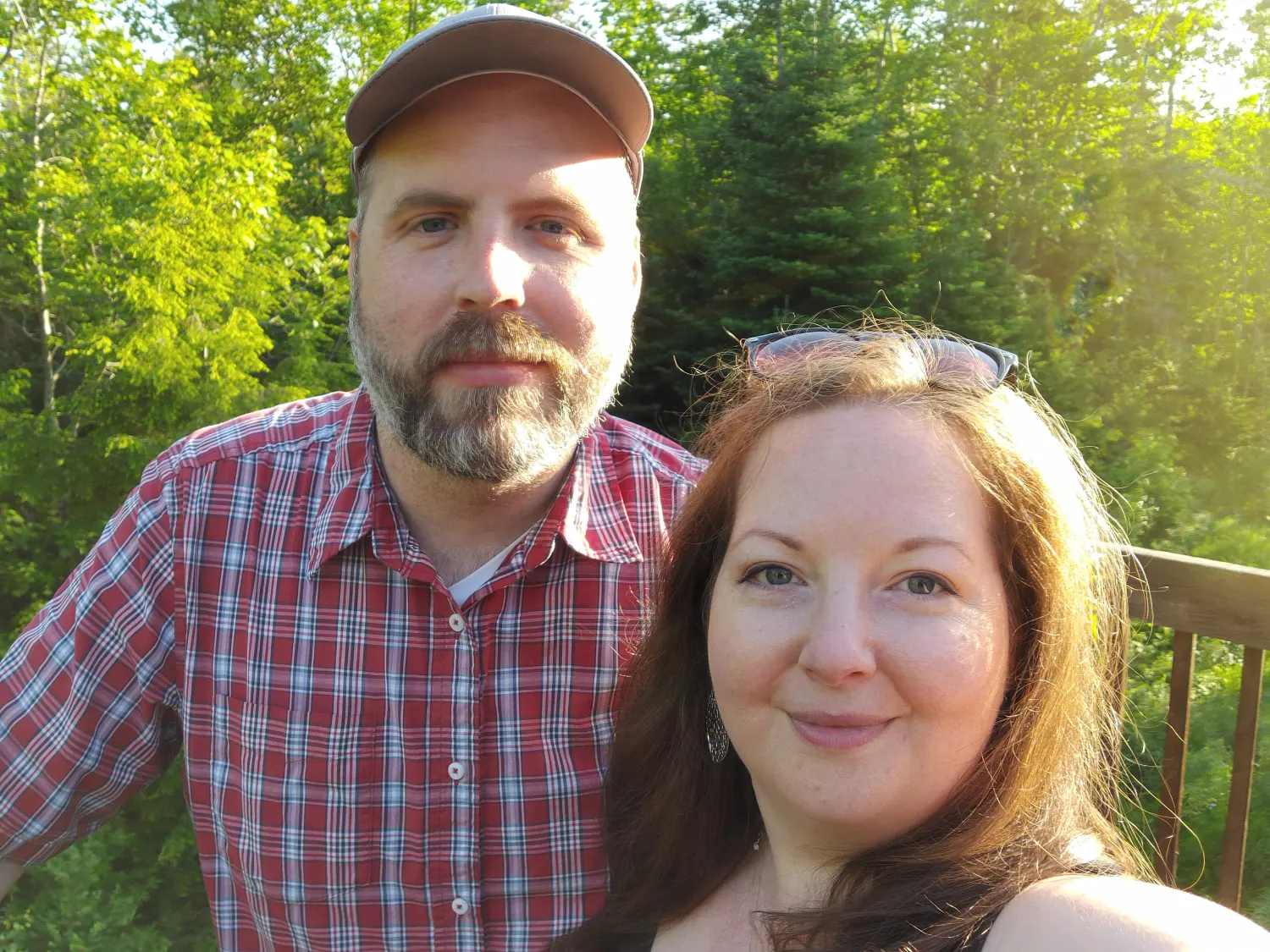 A photograph of Kyle Kelly and Jenn Kelly, of Covet standing in front of a forest.